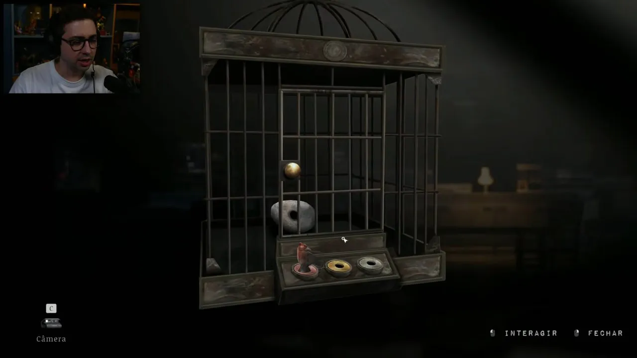 Cafe bird cage with the red statue placed and empty yellow and silver slots